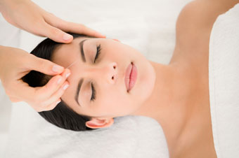 image of relaxed woman getting acupuncture
